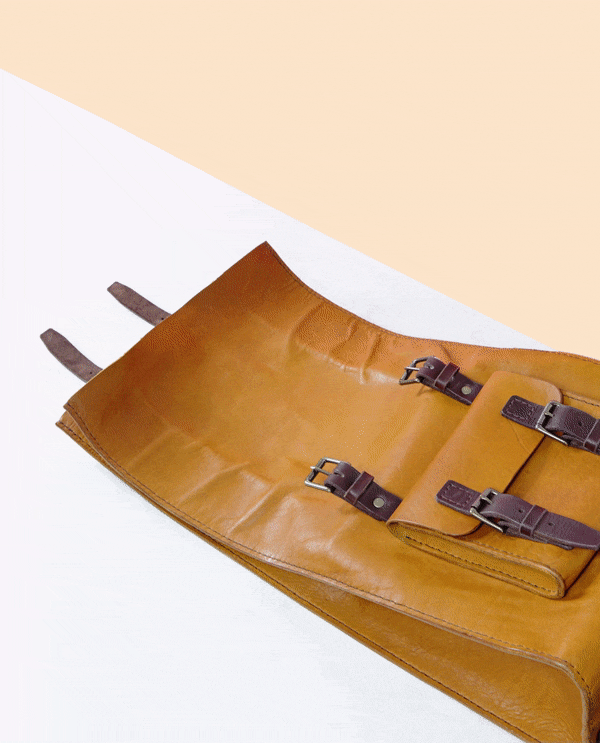 Gif of handmade leather rolltop, military style backpack opening and closing