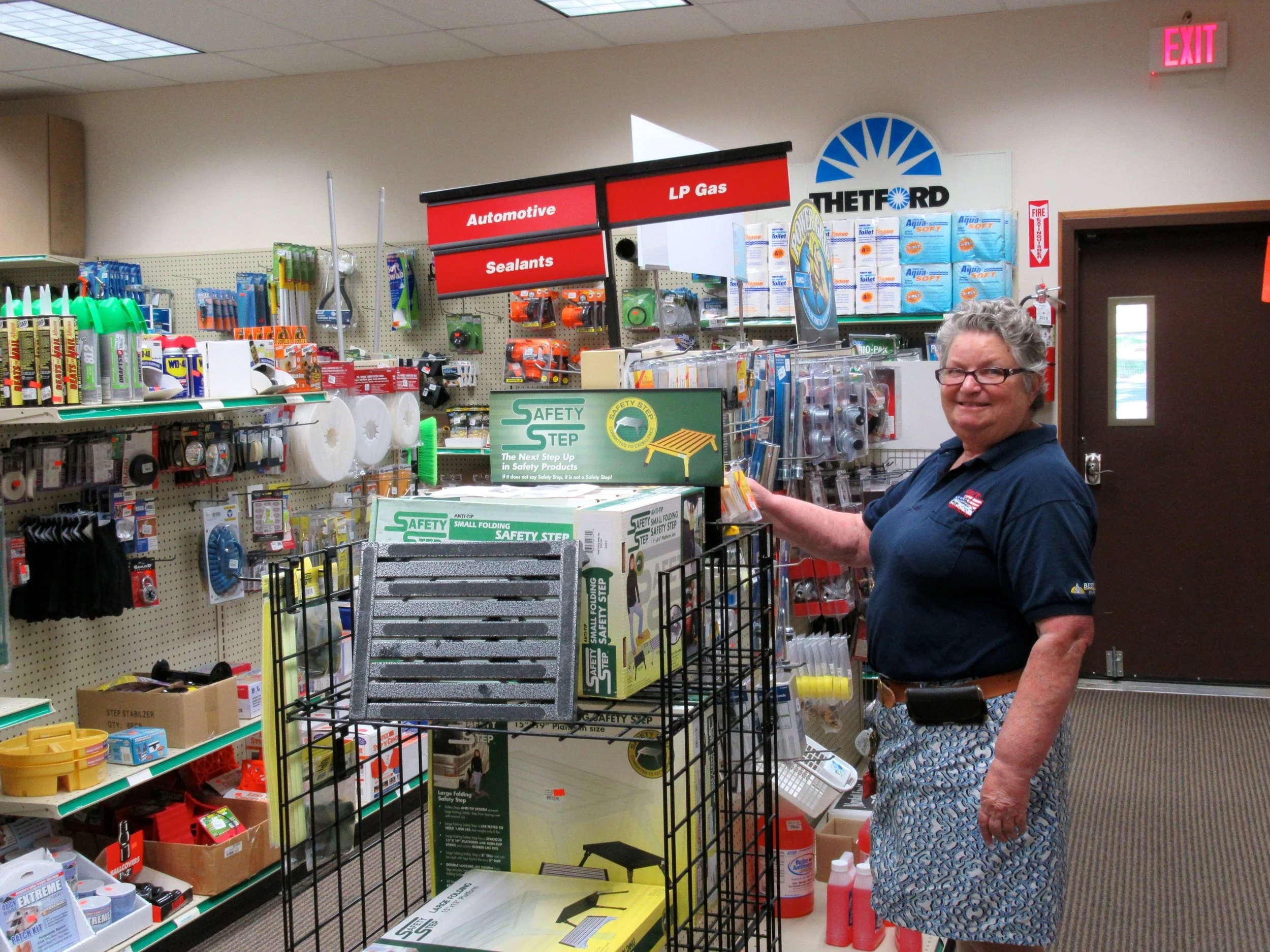 Employee Stocking Gas Fittings in Cherry Hill Park's RV Store