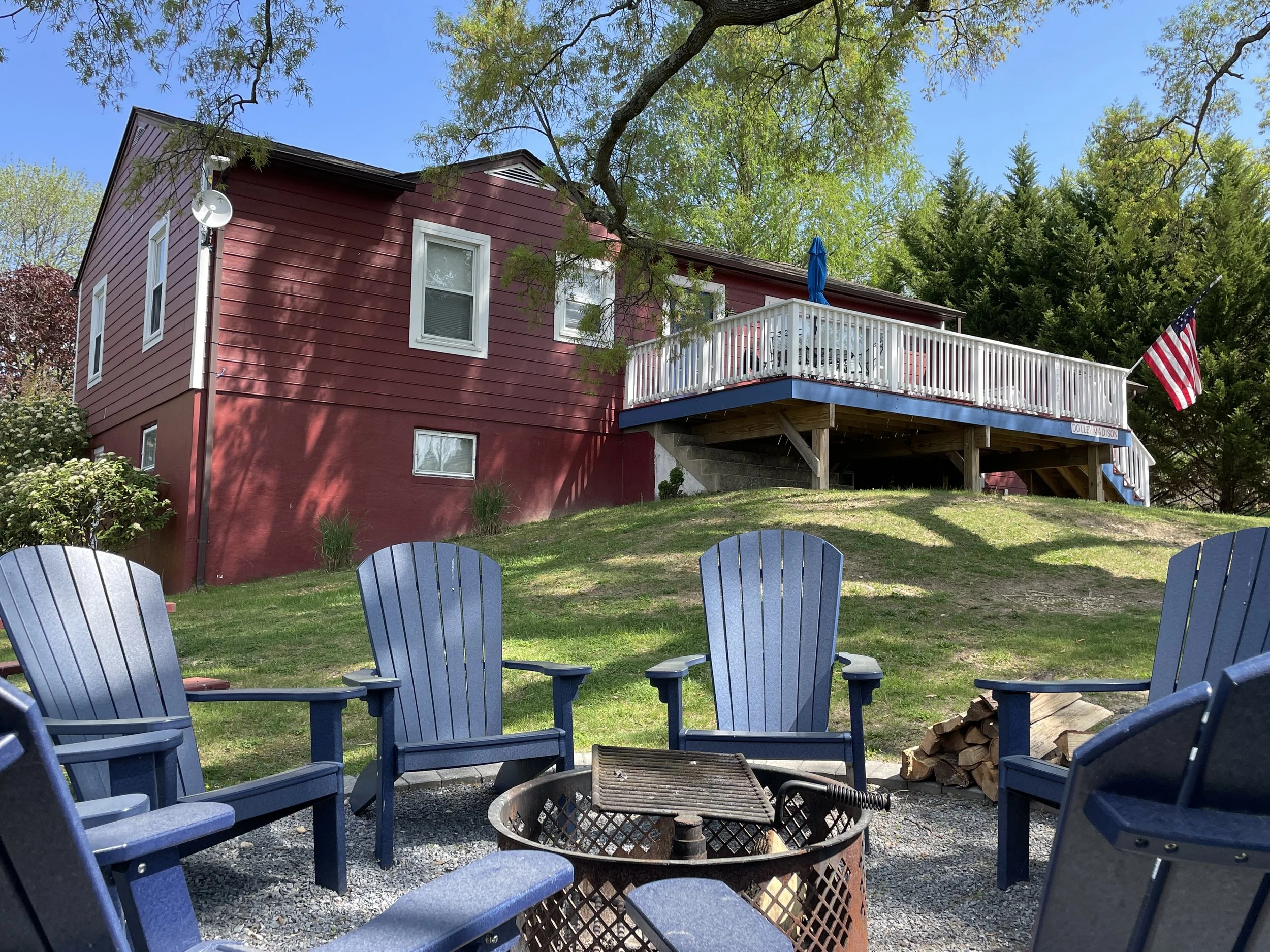 Cottage 3 Exterior with fire pit and deck.