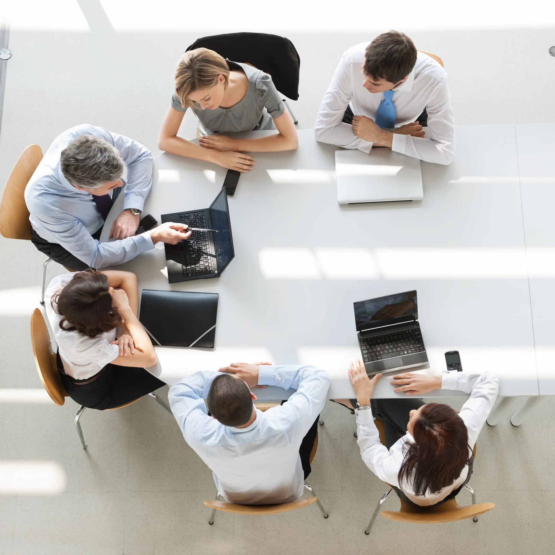 Overhead-view-of-business-people-in-a-meeting-155391664_5645x4032.jpeg