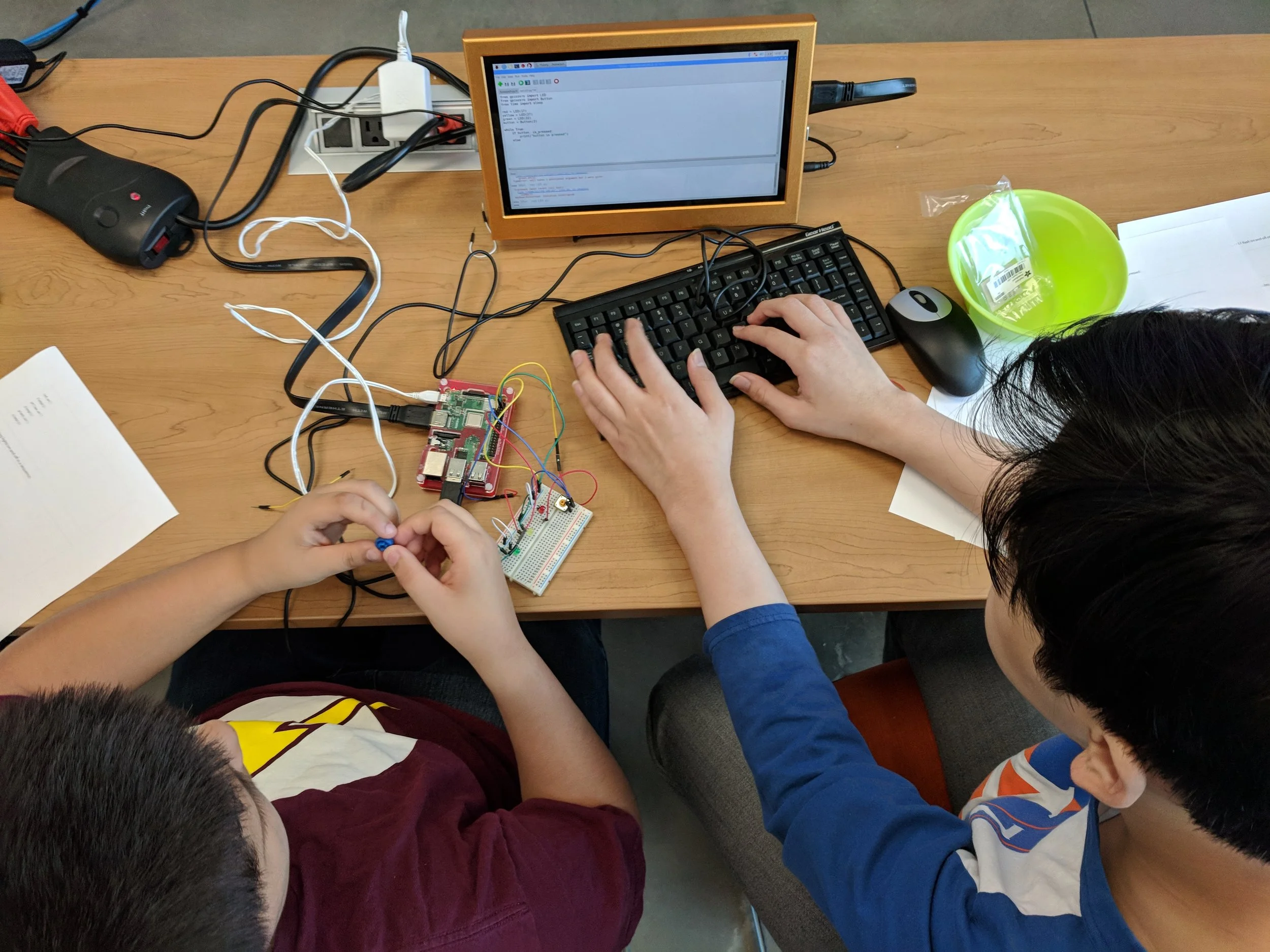 Day two of Invent to Learn at Fab Lab East Aldine, students work together to program a "traffic light" sequence with a circuit they built. July 25th 2018. Courtesy of Wanjun Zhang