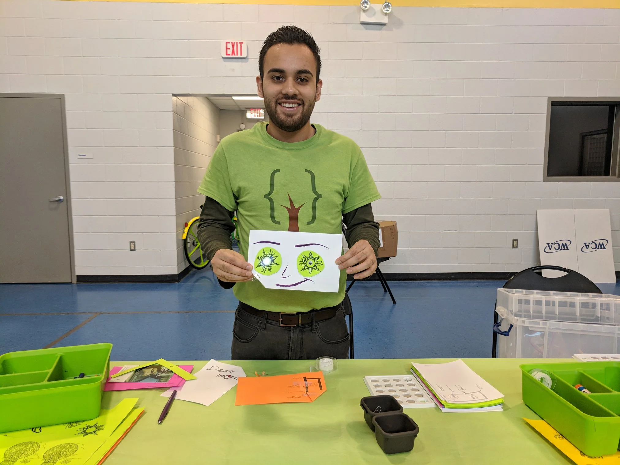 Volunteer and Software Developer Bryan holding up his creation at the one day STEM Camp at Finnigan Park Community Center. July 7th 2018. Courtesy of Wanjun Zhang.