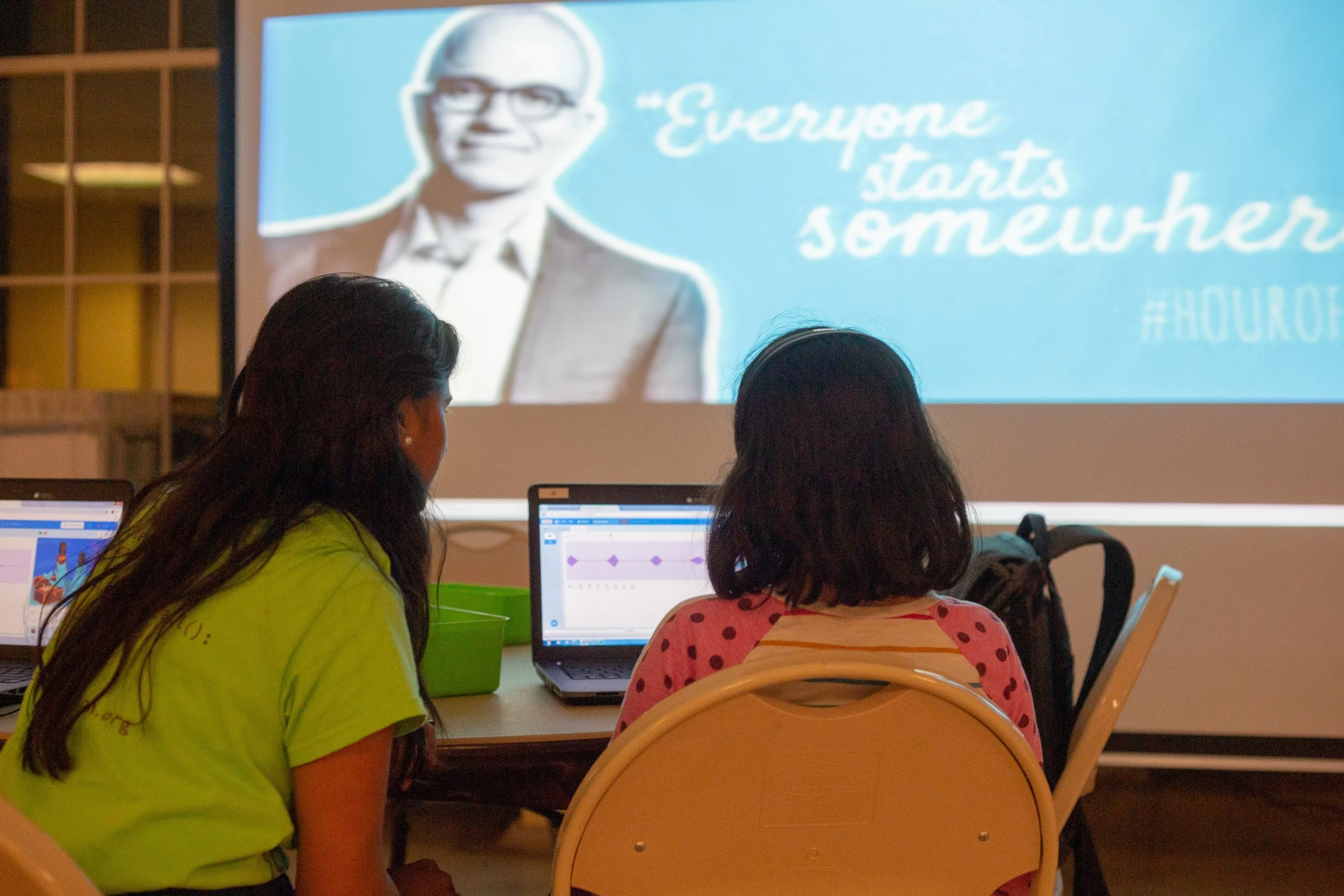 Volunteer Krishna helps students with their Hour of Code activity as part of CS Education week. Leonel Castillo Community Center. Courtesy of Wanjun Zhang. December 3rd, 2018.