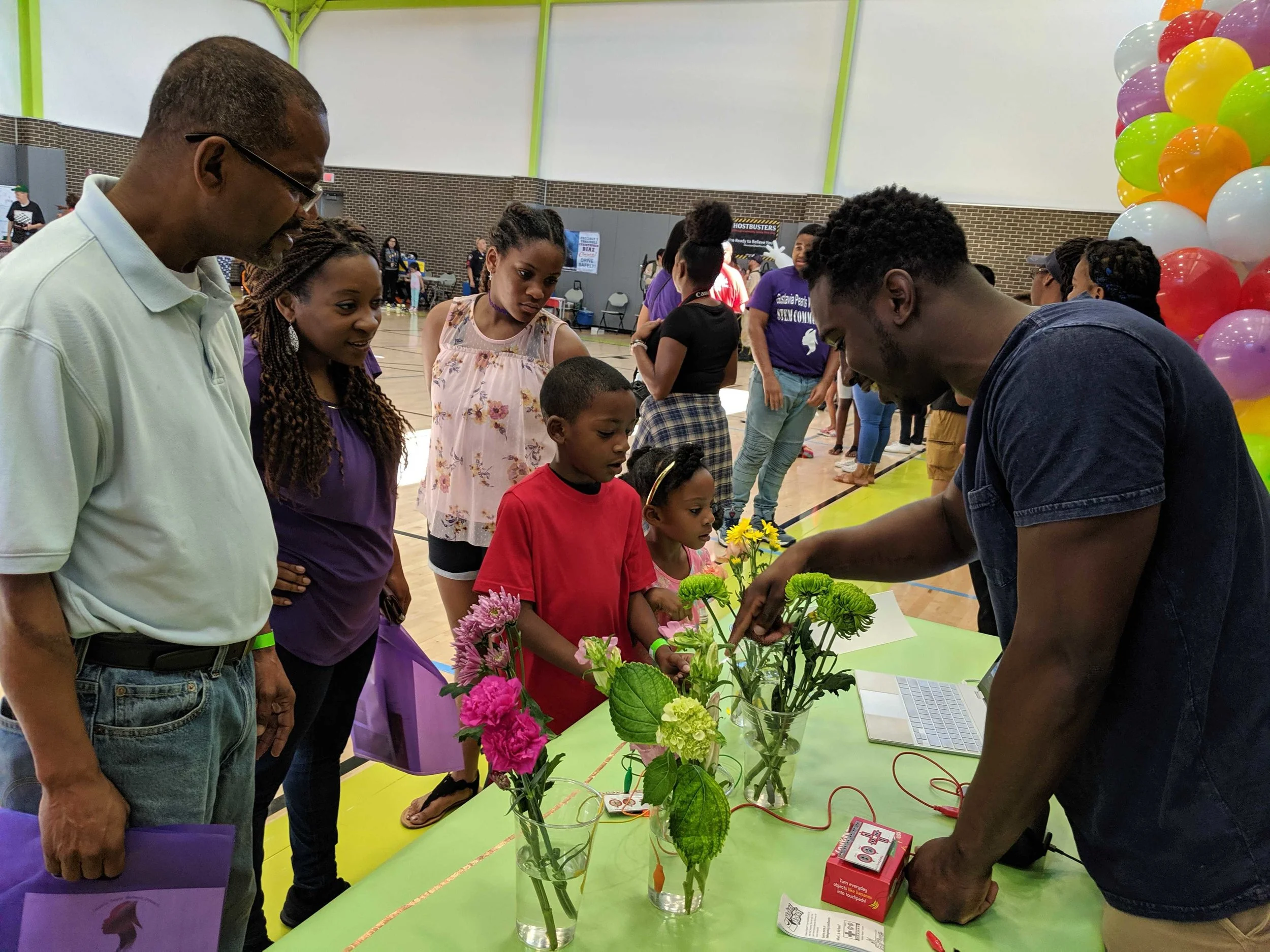 Our metaphorical garden. Jared Lake shows how to make beats with flowers at the STEM Community Day! Courtesy of Amanda Shih. June 8th, 2019.