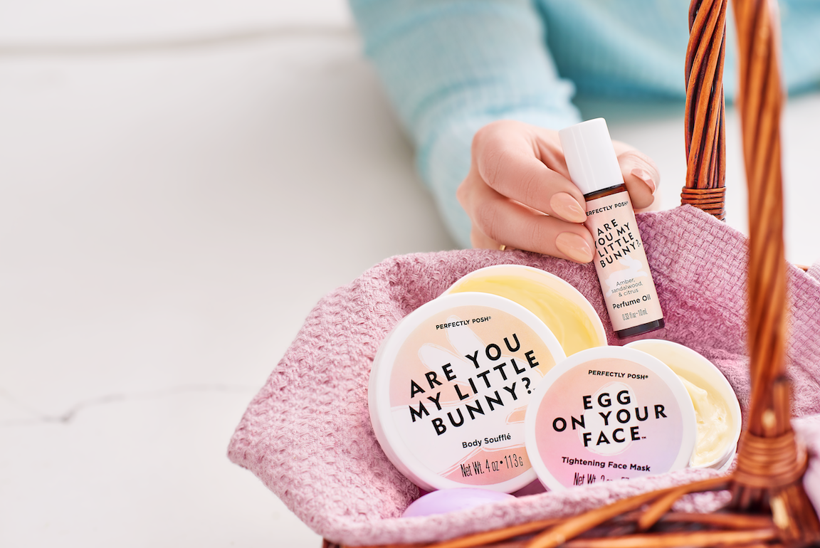 Perfectly Posh Basket Case Bundle stylized image with Are You My Little Bunny Body Soufflé, Egg on Your Face Tightening Face Mask with Poshbiotics, and Are You My Little Bunny Perfume Roller. Probiotic and prebiotic K-beauty Easter bundle