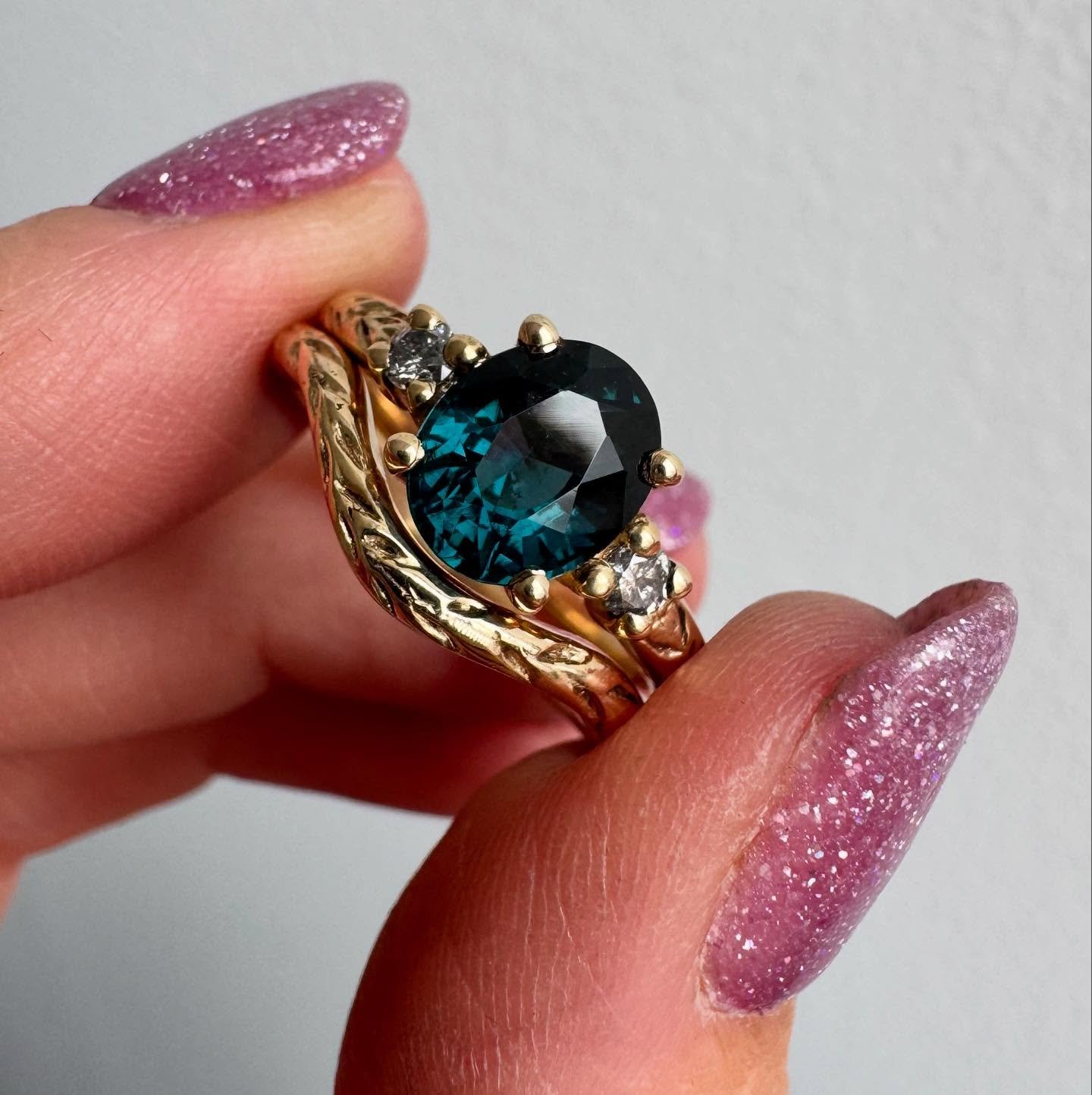 A custom bridal ring set and matching wedding band for Matt &amp; Alisha. 
14k, gray diamonds, and an unreal teal blue spinel. 
This ring was a journey and the end result exceeded my expectations. Blue spinel was initially selected as a cheaper alter