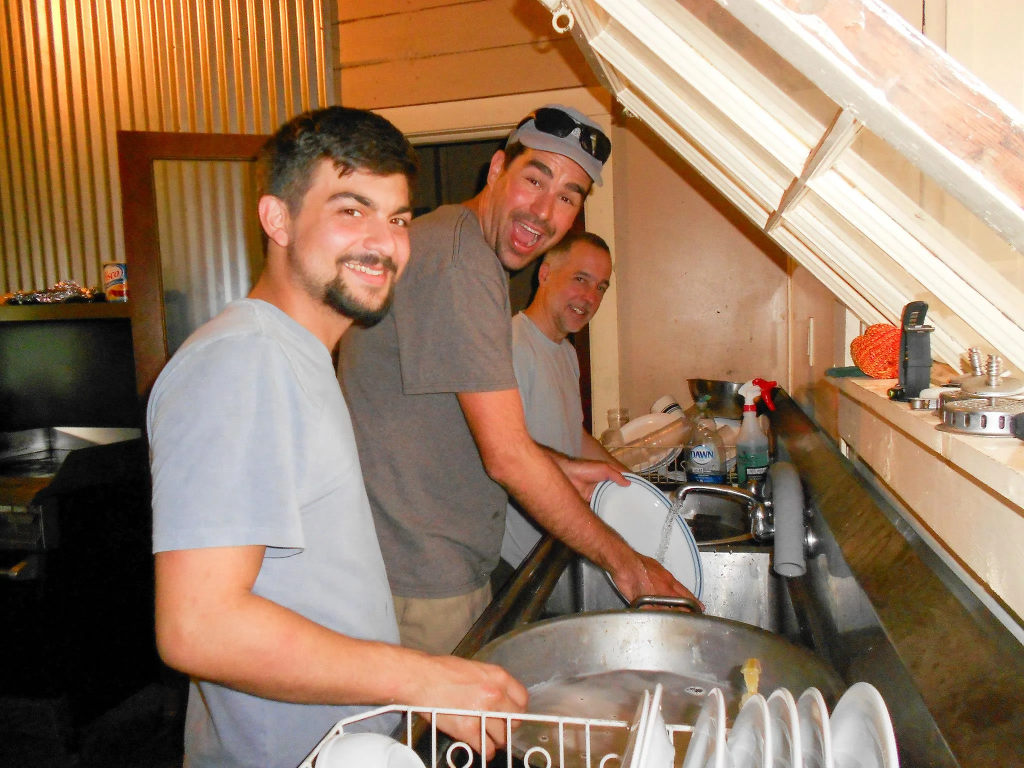 Cameron Dale, Cody Westheimer, and Stephen Lias wash the dishes at Coal Creek in 2015.