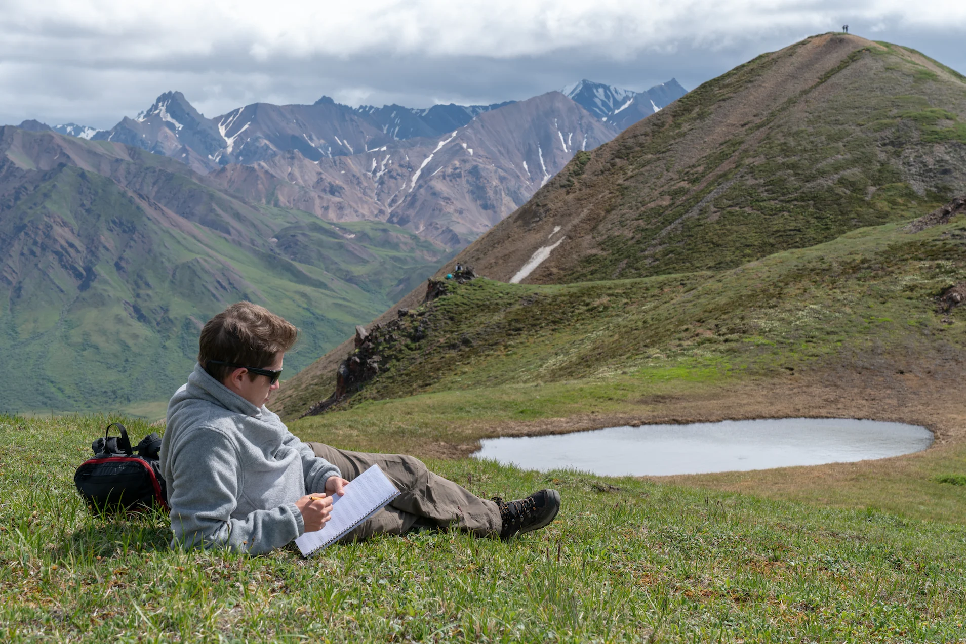 Composer Sasha Avanov drinks in the inspiration on the south side of Cathedral Mountain in Denali National Park (2018)