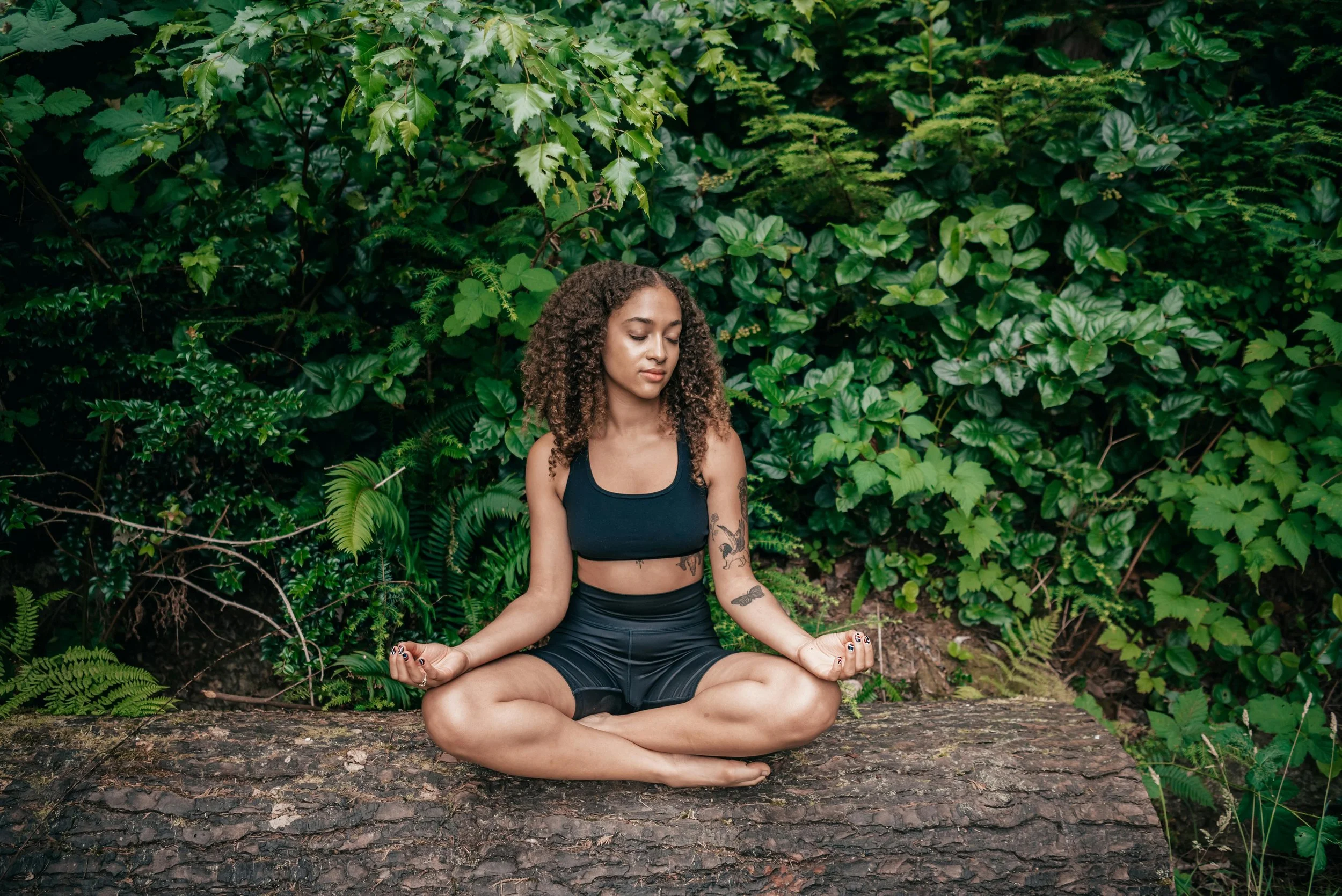 Woman meditating outdoors in nature, grounding technique