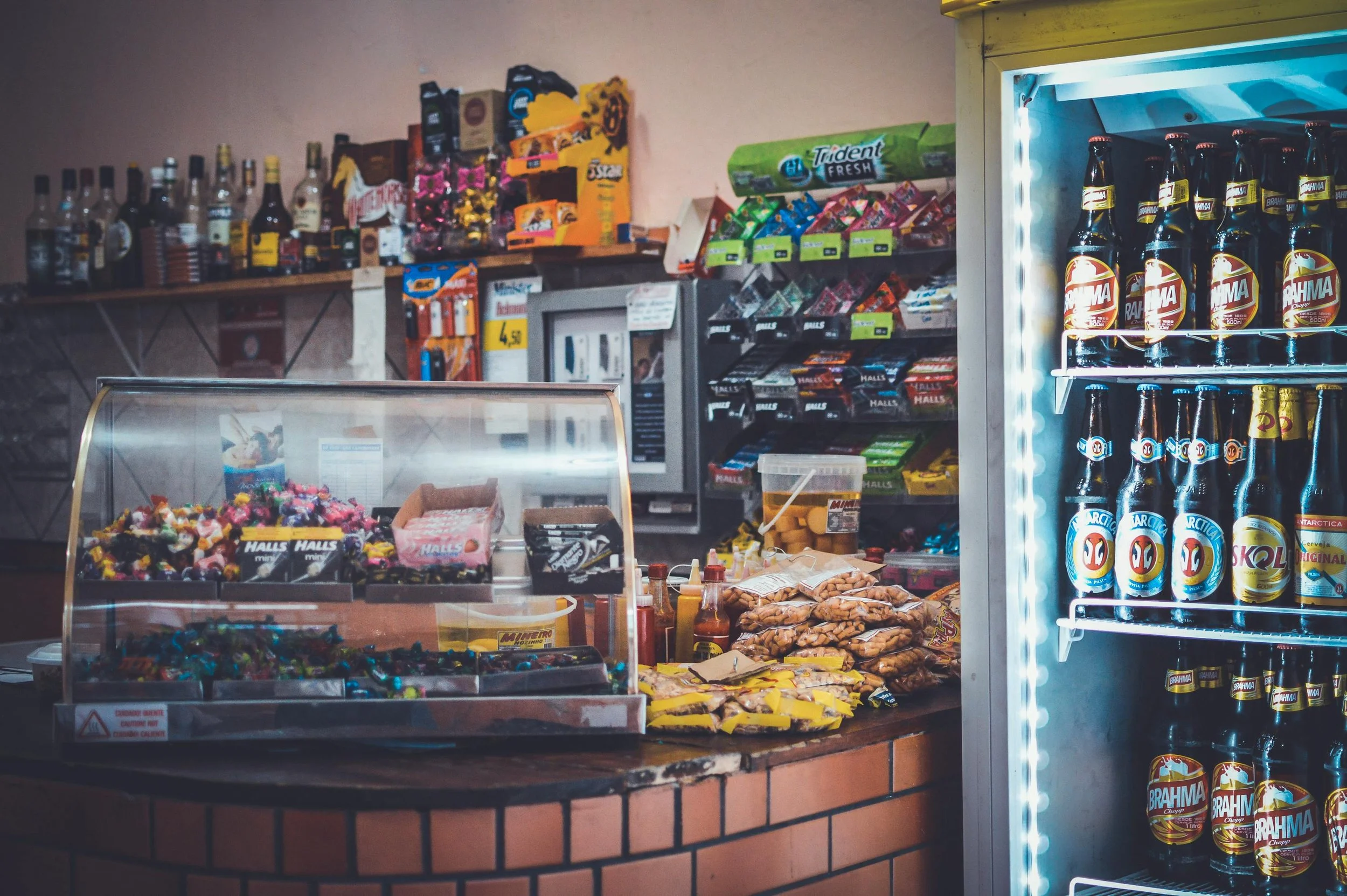 Interior of a convenience store counter with drinks and snacks