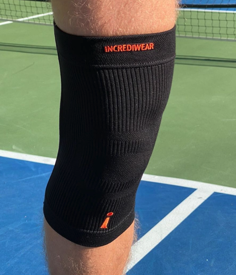 Incrediwear Knee Sleeve worn on a tennis court, representing the Incrediwear Knee Sleeve Review