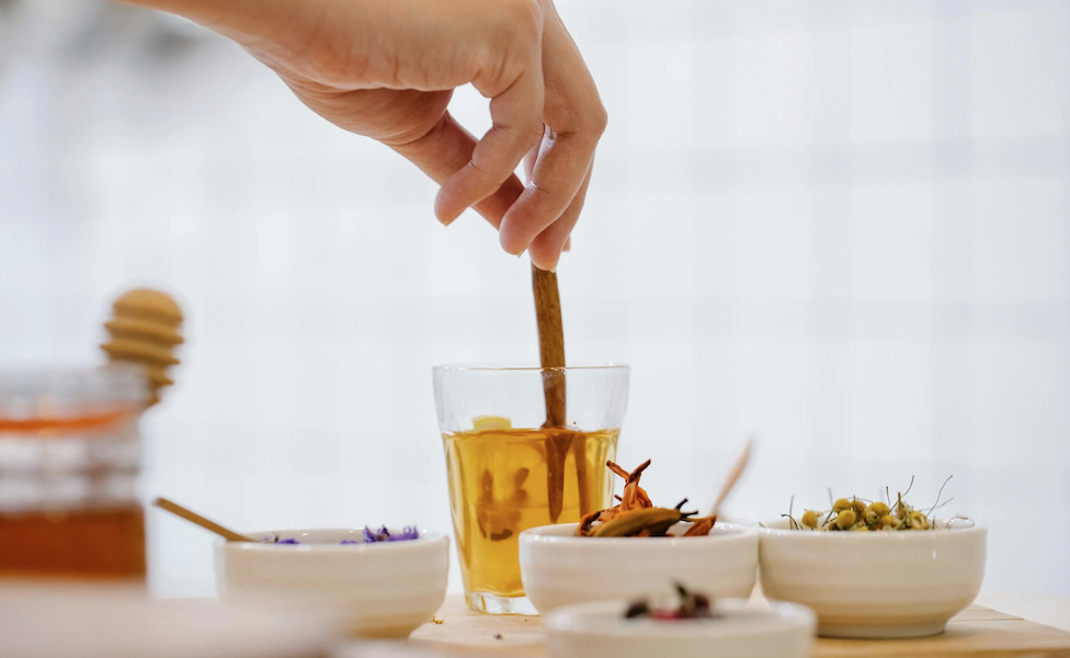 herbal tea with honey being stirred as a natural remedy for cold and flu to support immune health and recovery