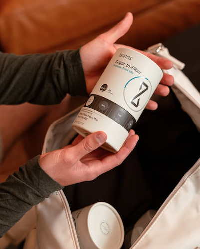 ZBiotics Sugar-to-Fiber canister being packed into a travel bag