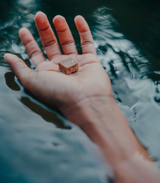 KA! Empathogenics kanna chew held in hand over water