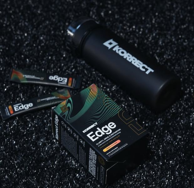 Korrect Edge supplement box and single-serve sticks next to a black Korrect water bottle.