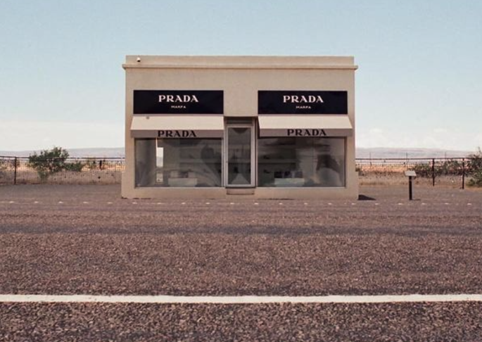 The Prada Marfa art installation standing alone along a desert highway outside Marfa, Texas