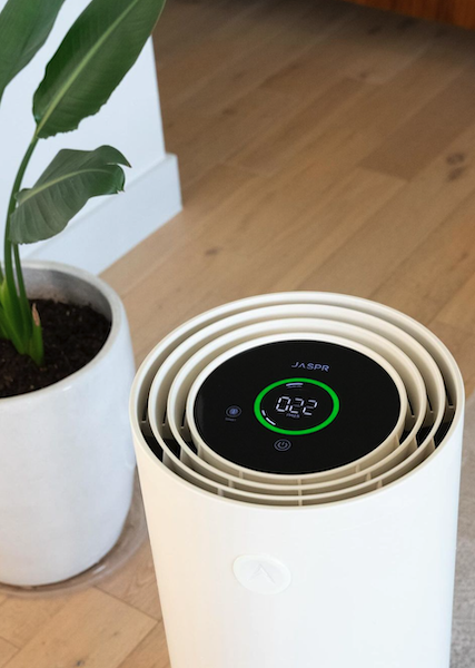 JASPR air purifier displaying real-time indoor air quality levels with digital monitoring screen in a modern home setting.