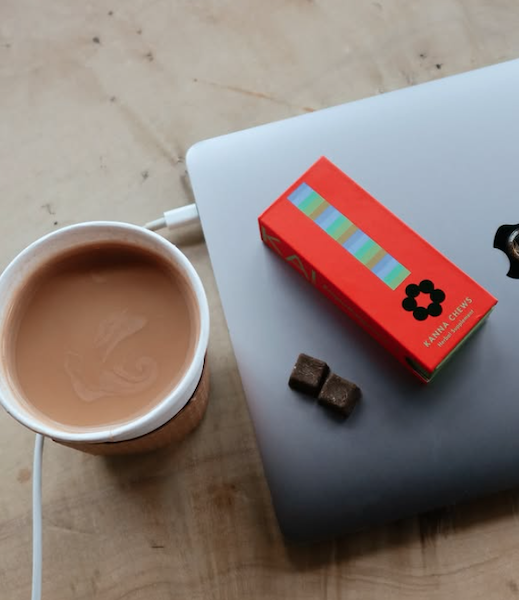 KA! Empathogenics kanna chews next to coffee on laptop during daily routine