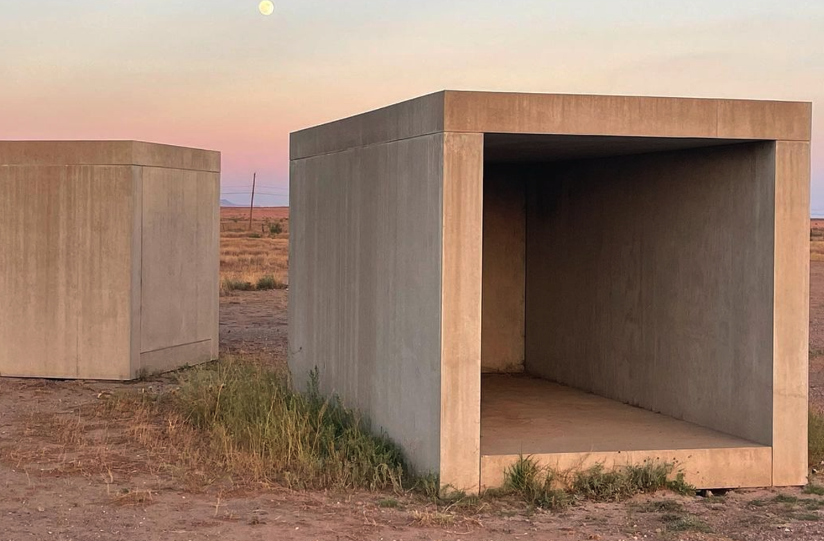 Donald Judd's concrete box installations at dusk in Marfa, Texas with the moon rising overhead