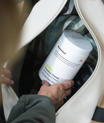 Momentous creatine chews container inside gym bag for daily supplement routine and convenient performance support