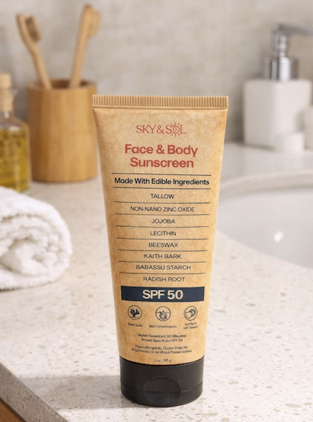 Sky and Sol Face and Body Sunscreen SPF 50 tube on a bathroom counter as part of a daily skincare routine