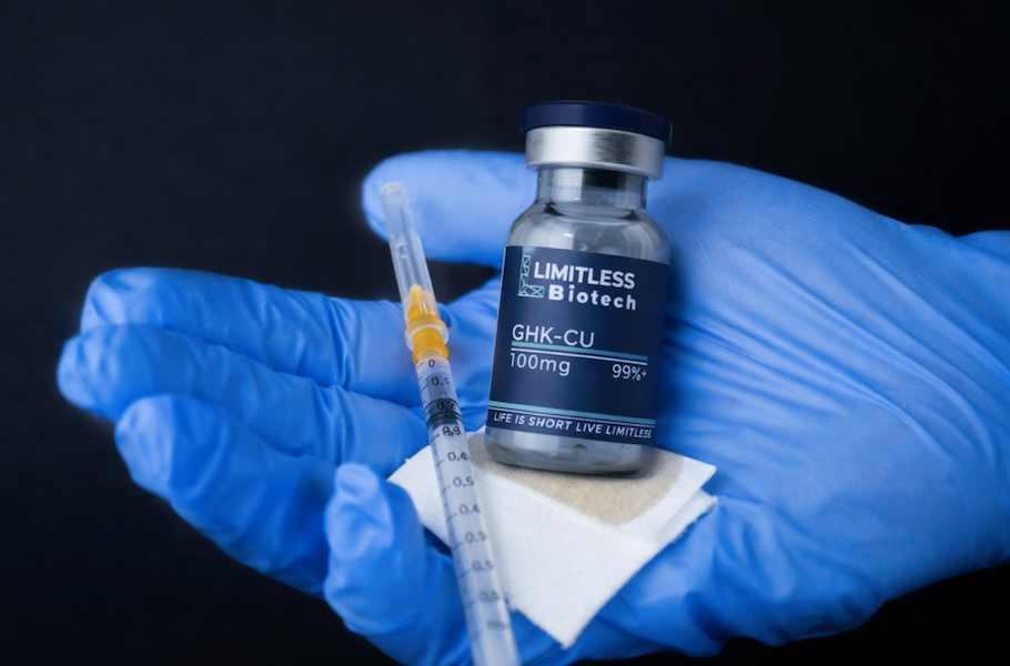 Limitless Life Nootropics GHK-CU peptide vial with syringe in gloved hands, representing injectable copper peptide therapy used for collagen production, skin repair, and anti-aging benefits.