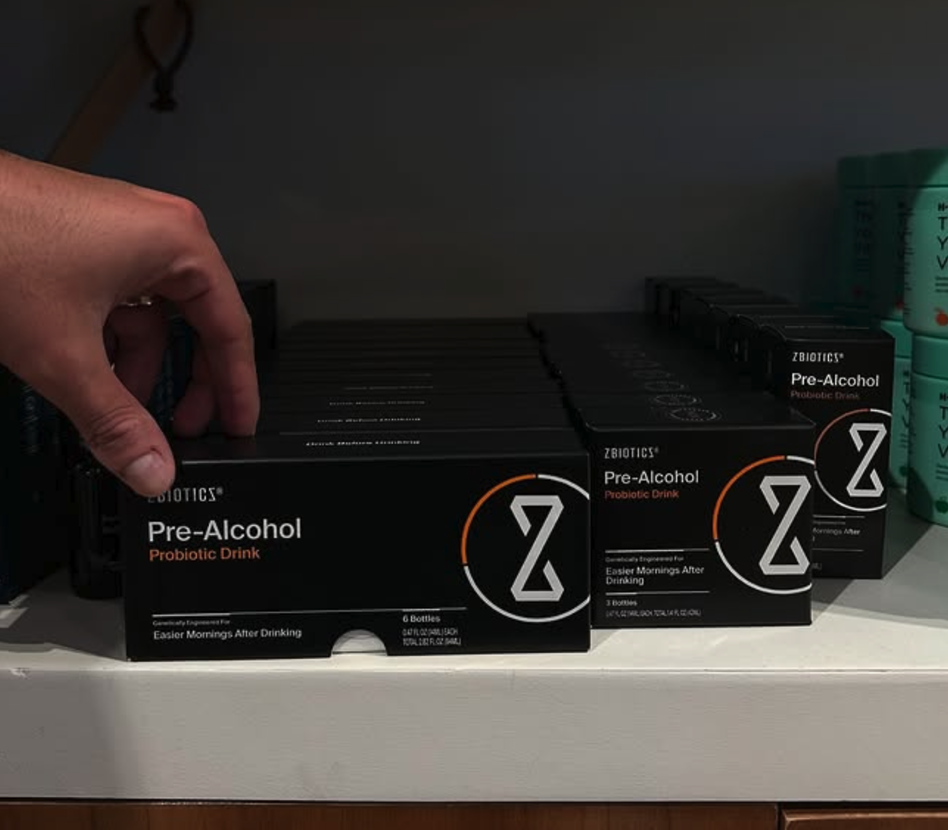 ZBiotics Pre-Alcohol boxes stacked on a shelf, showing available 6-pack and 12-pack sizes