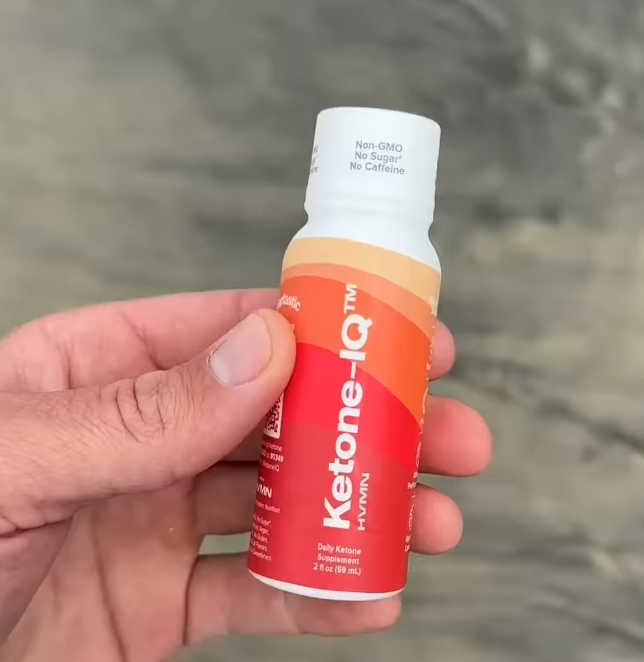 Ketone IQ exogenous ketone supplement bottle held in hand, used during a water fast
