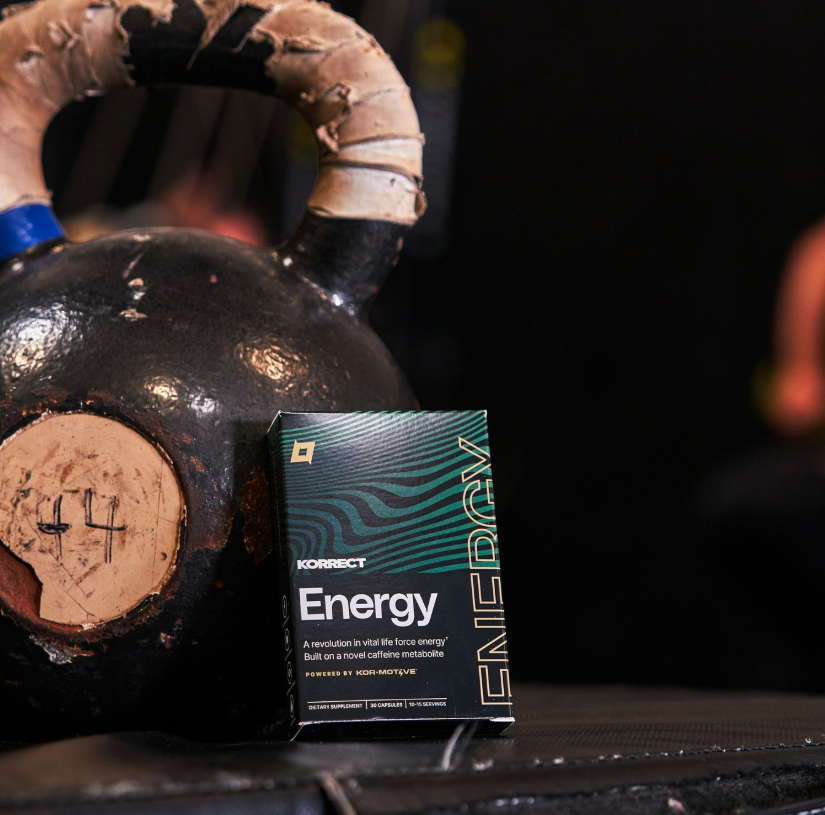 Korrect Energy supplement box placed next to kettlebell in gym setting