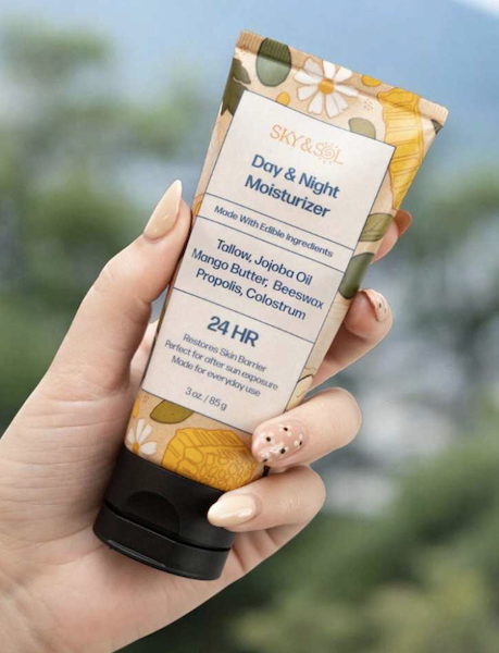 hand holding Sky and Sol day and night moisturizer showing tallow based clean skincare for daily hydration and skin barrier support