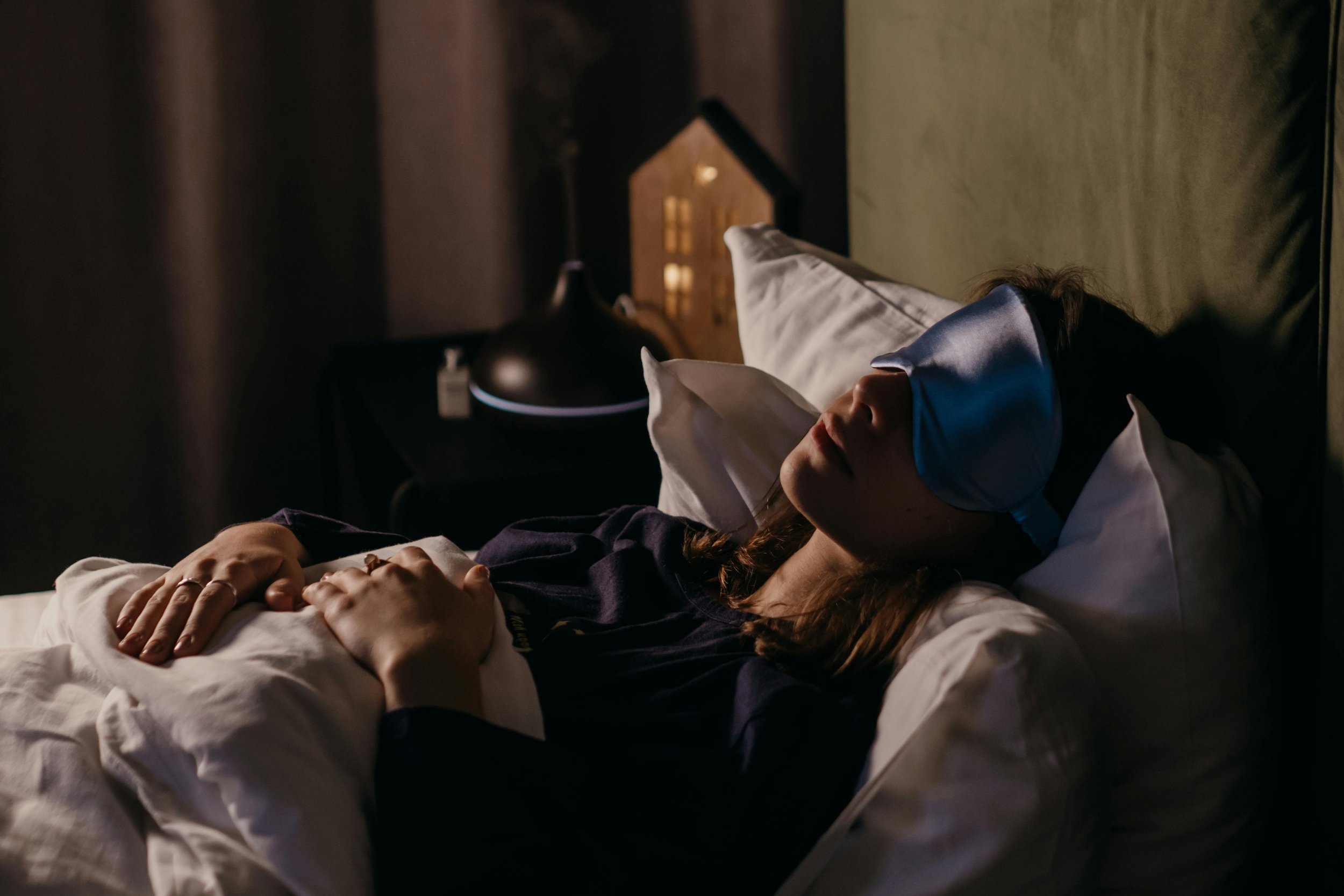 Woman sleeping wearing a silk sleep mask