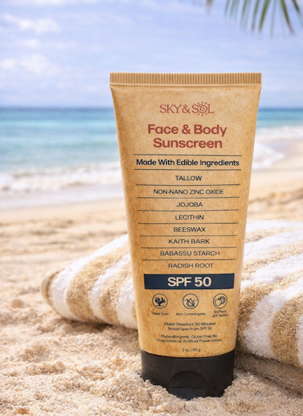 Sky and Sol Face and Body Sunscreen SPF 50 tube on a beach towel, representing the Sky and Sol Sunscreen Review