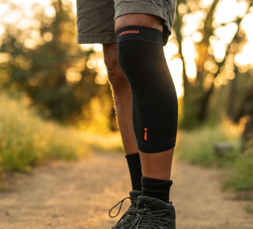Incrediwear knee sleeve worn while hiking on a trail at sunset