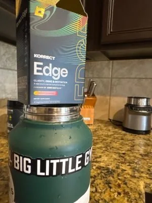Korrect Edge box resting on a water bottle in a kitchen