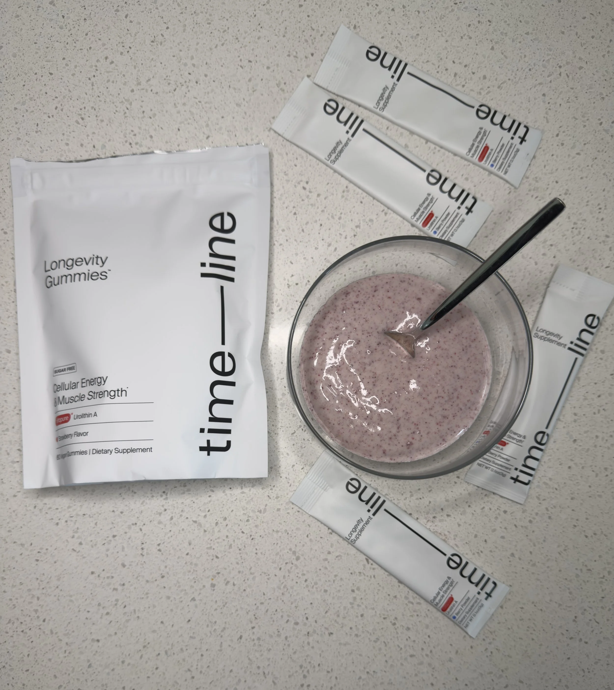 Timeline Mitopure gummies bag and powder mixed into a yogurt bowl, representing the Mitochondria Hacks guide