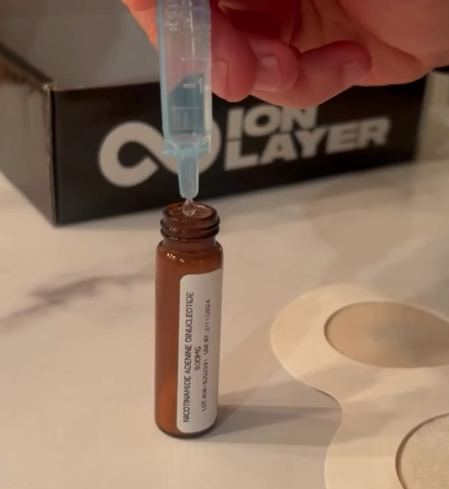 Vial labeled Nicotinamide Adenine Dinucleotide 500mg next to the Ion Layer box