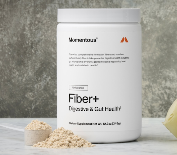 Momentous fiber supplement powder next to container for gut health digestion support and daily fiber intake