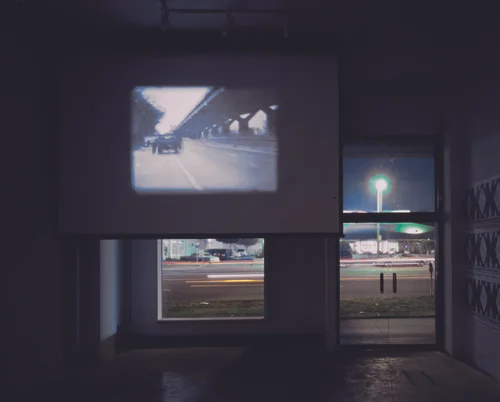 Rirkrit Tiravanija, Untitled (A trailer for a film), 1999, Film, scaffolding, and posters