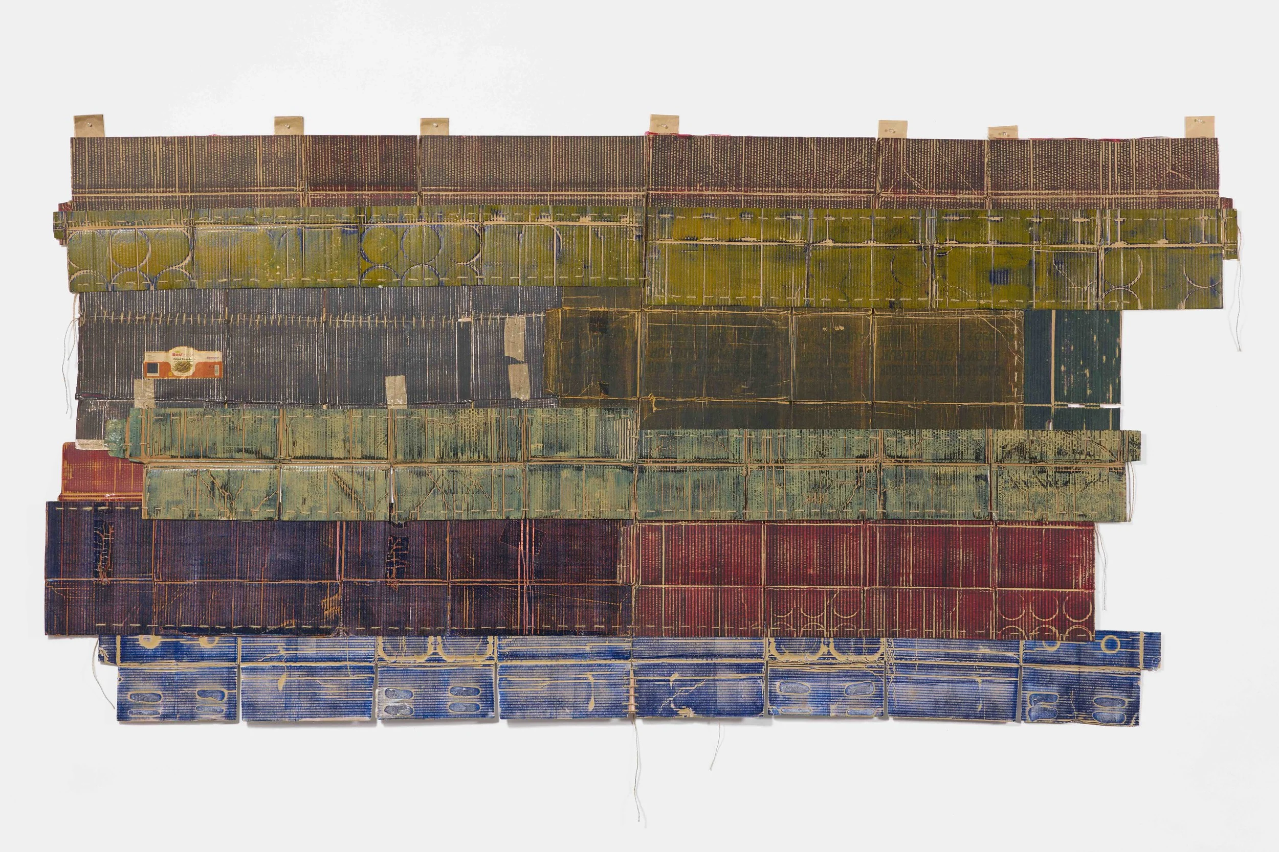 Stolon Press, Mixed Business No. 1 (2025); cardboard boxes from global trade, etching ink, jute thread; 110.24 x 62.99 inches; 280 x 160 cm
