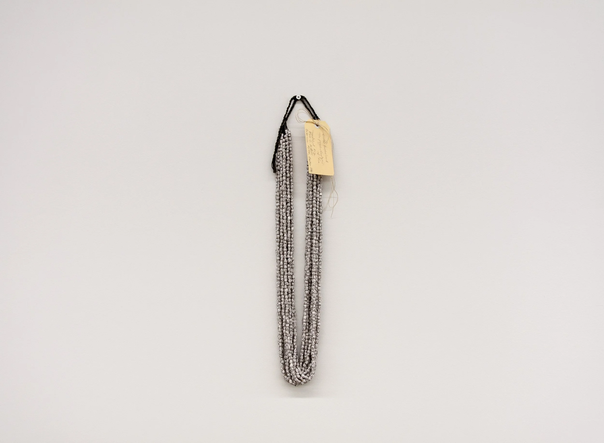Simryn Gill, Pearls (Gaston Bachelard, The Psychoanalysis of Fire, Translated by Alan C. M. Ross, Beacon Press, Boston, 1964) (2024); Paper, glue, cotton; 13 strands, 60.5 cm