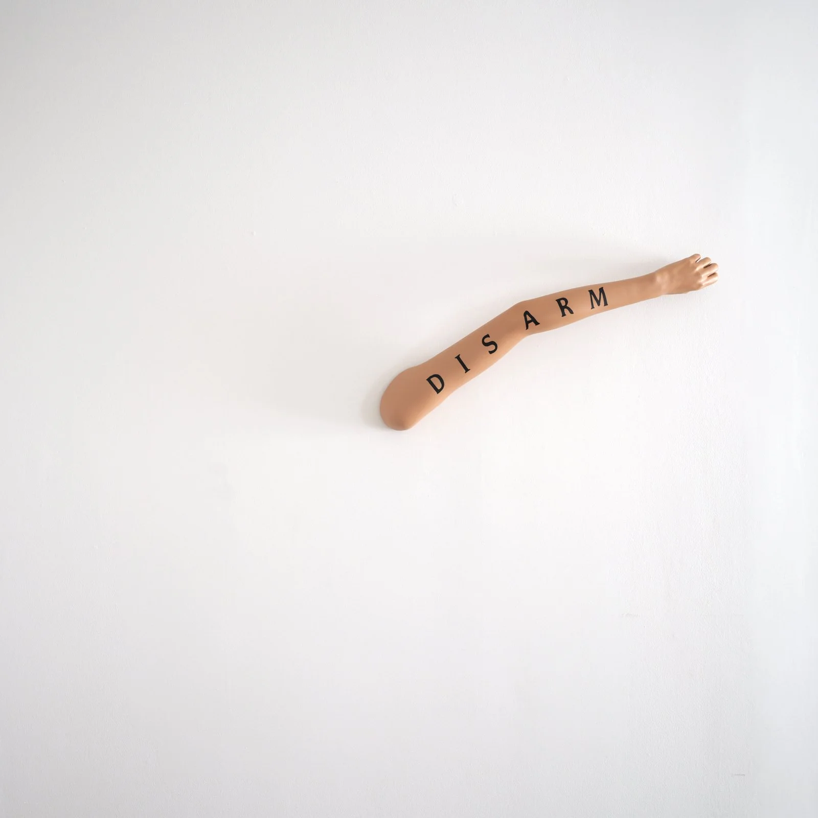 Fiona Banner, Time, the anti-hero (2025); Mixed media, mannequin arm, paint, clock mechanism, electrical components; 59 in⌀; 150 cm⌀