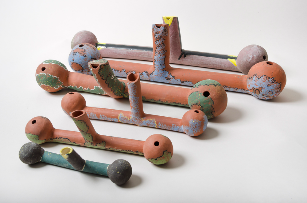 Polyglobular water flutes , 2 balls (globes,) 2 tubes; the red clay ones are fairly recent; my older one is in the back of both pictures. Water flutes use chance and skill in play, the chance comes from the movement of the water, the skill from changes in air pressure and movement control. Front small flute is 3"H X 8"W X 1.5"D, & warbles higher