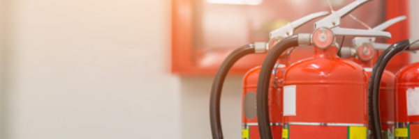 How often should fire extinguishers be checked?