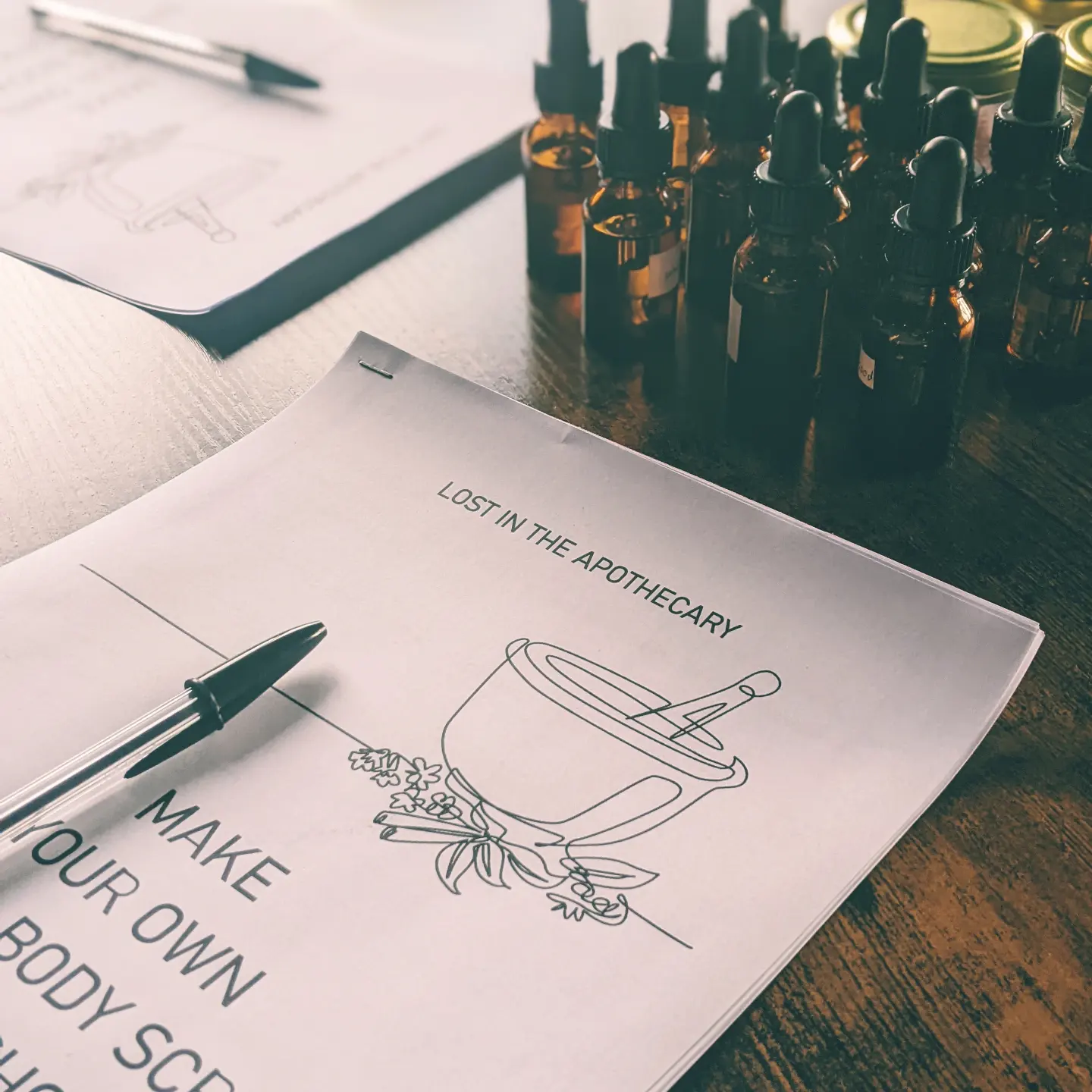 dropper bottles and workbook on table.png