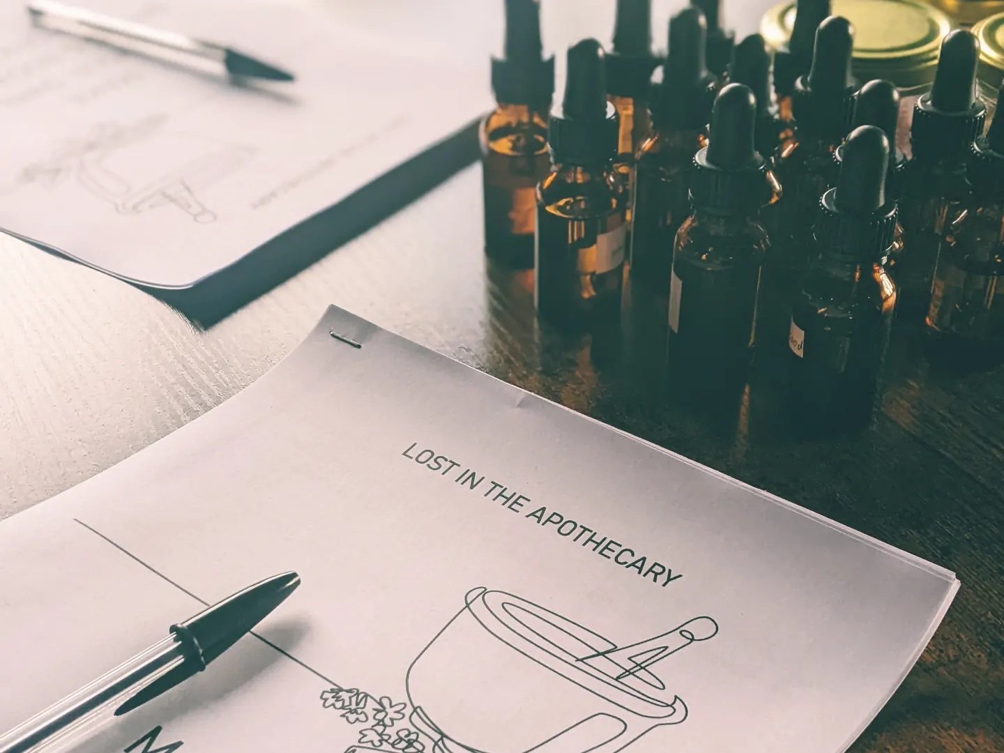 dropper bottles and workbook on table.jpg