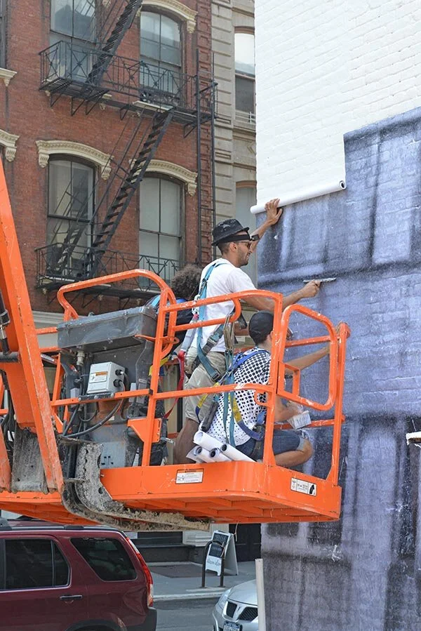 JR installing his art in Tribeca. Photo: courtesy JR.