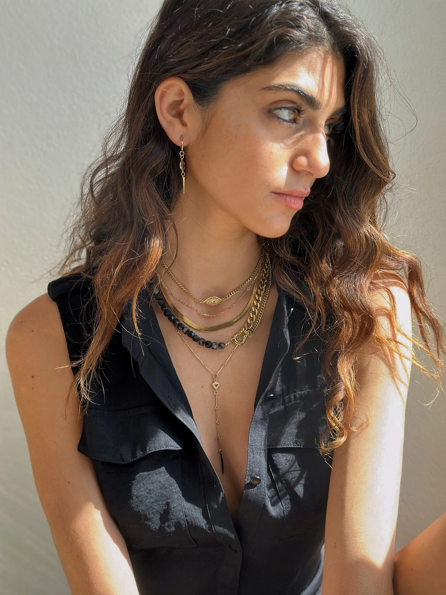 A piece that completes every necklace stack? Our signature Shackle Duo Necklace. The faceted black tourmaline cubes style is designed to move with you through fall and winter &mdash; its subtle sparkle and dark-toned edge make it the perfect finishin