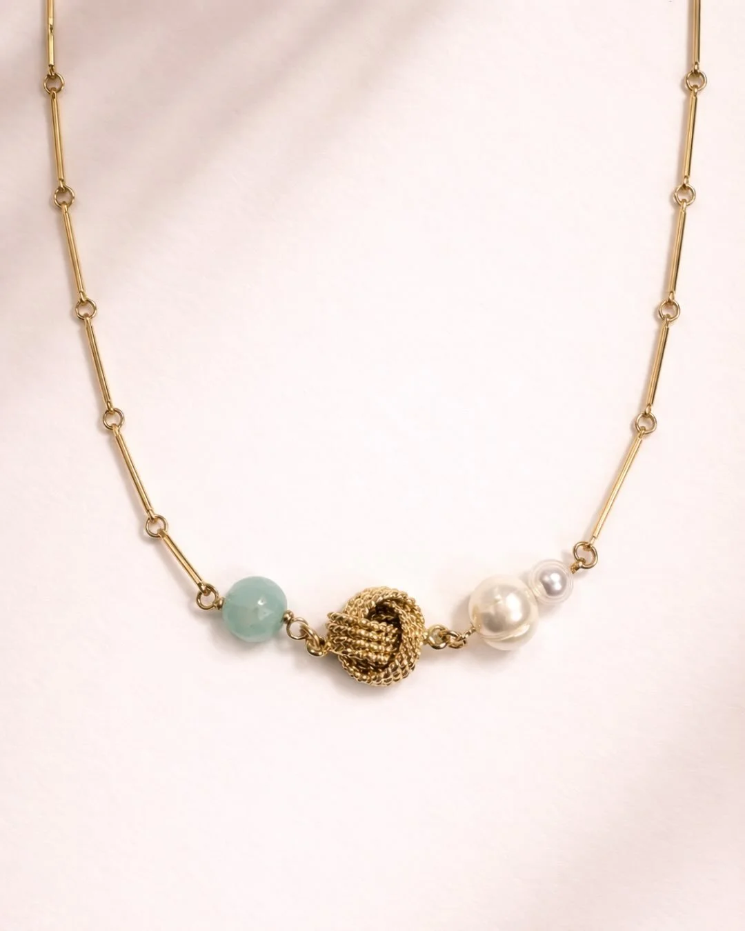 Spring called. It wants effortless elegance, and this is it. The Tide Has Turned checks every box: easy to wear, layers like a dream, and elevates everything. Aqua chalcedony meets freshwater pearls with a gold knot that ties it all together. Literal