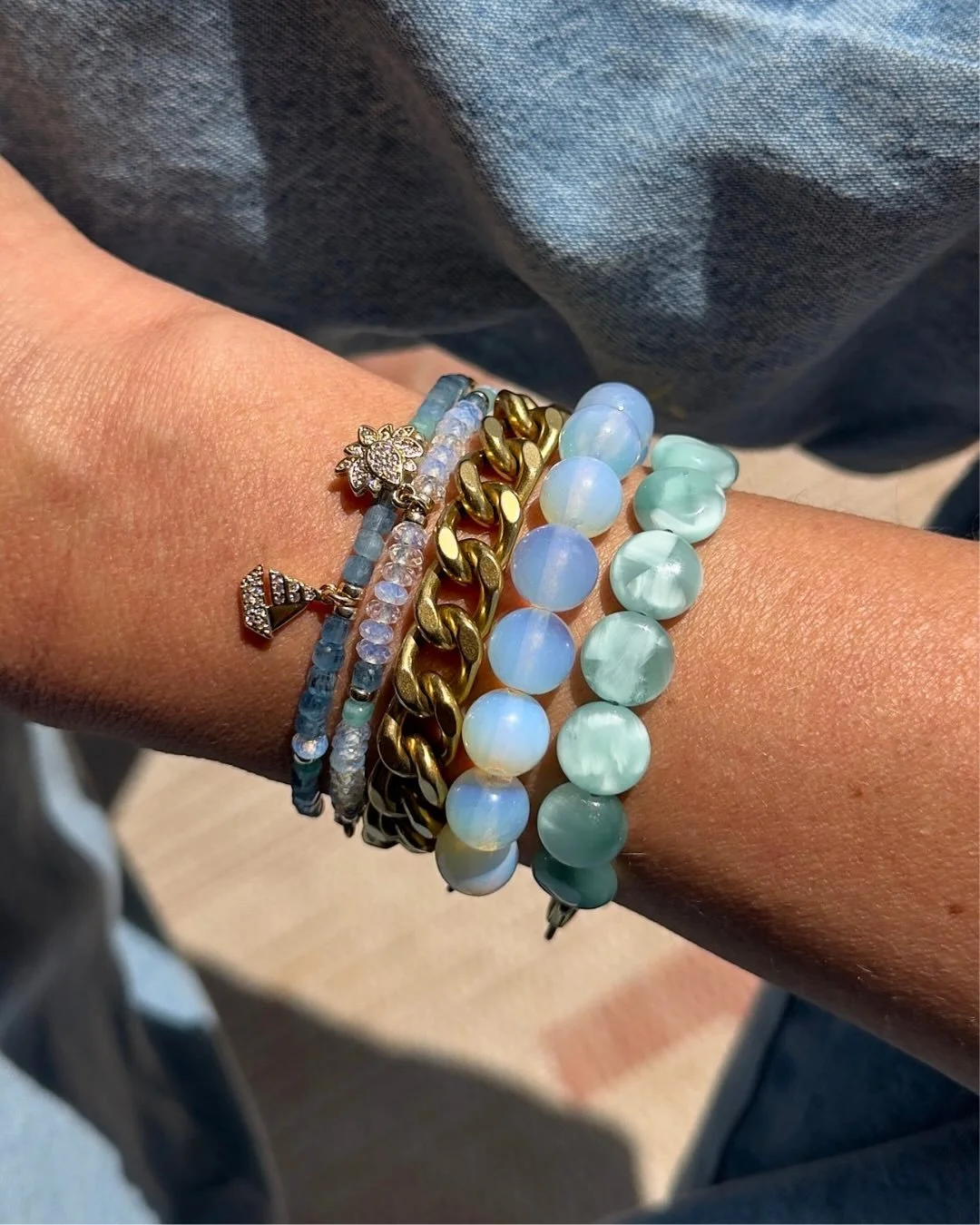Raw-Cut Santa Maria Aquamarine channels the serene blues of sky and sea. Paired with luminous Opalite, every glance catches a flicker of light and sparkle.

#aquamarinebracelet #opalitebracelet #beadedbracelets #rachelnathan