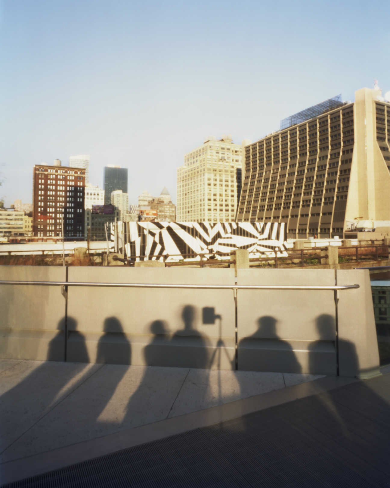 View of buildings from the Highline with shadows of people
